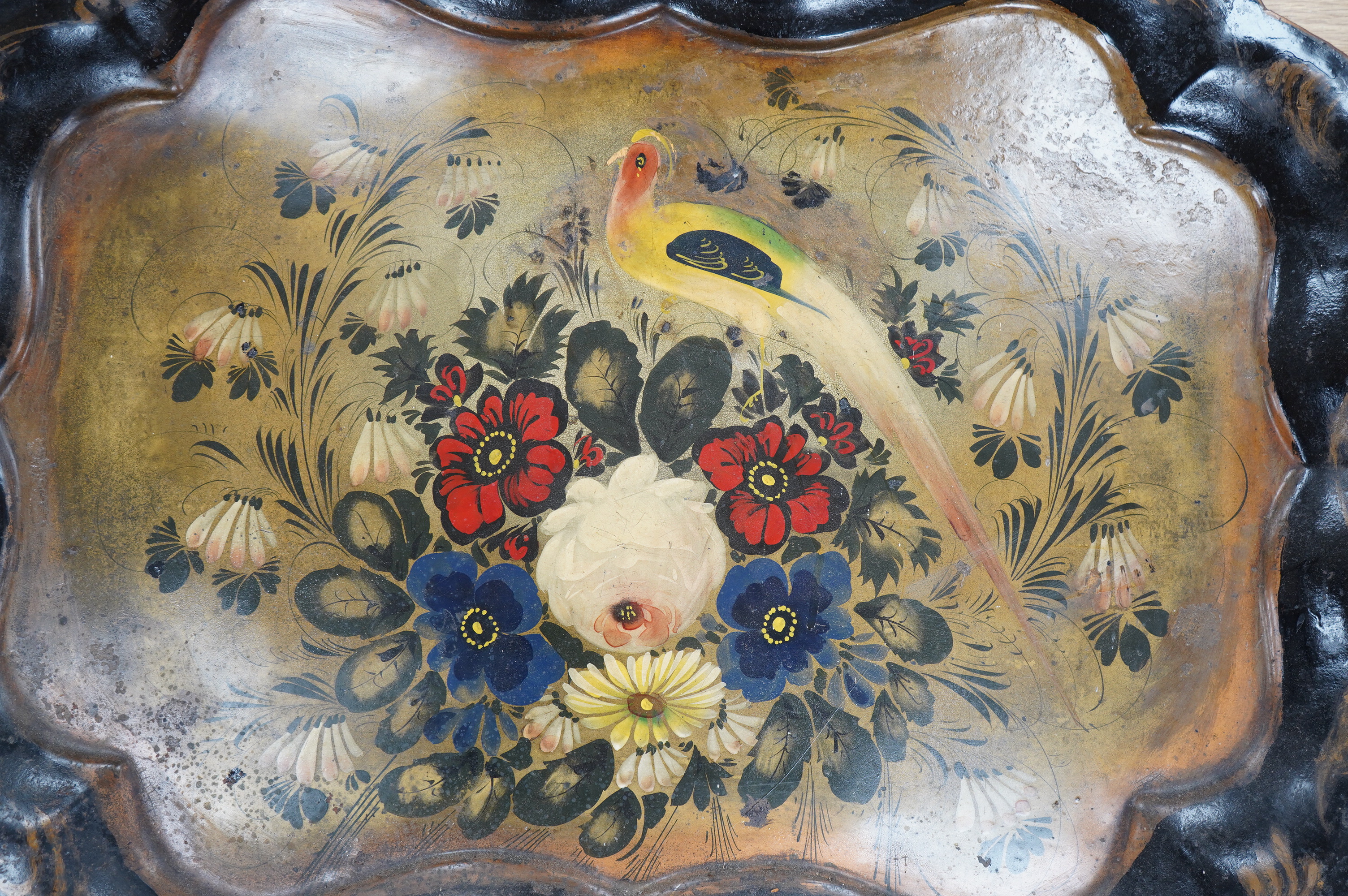 A 19th century japanned toleware tray, painted with a pheasant and flower decoration, 77cm wide. Condition - some pitting to surface